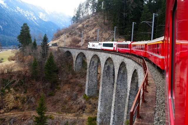 A red train going over a bridge