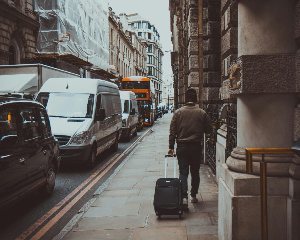 A man pulling his luggage through London
