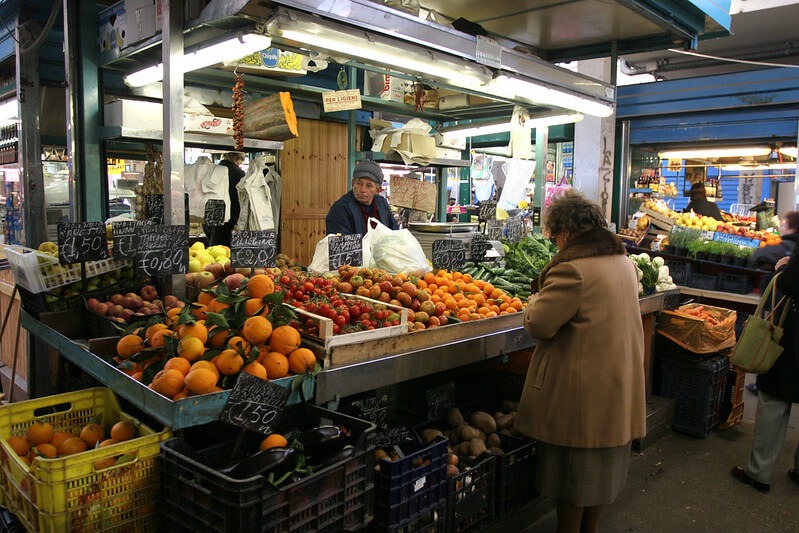 testaccio community market with fresh oranges, tomatoes, and other fruits hidden gems in rome