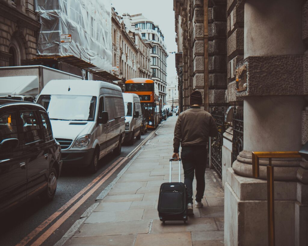 A man pulling his luggage through London 